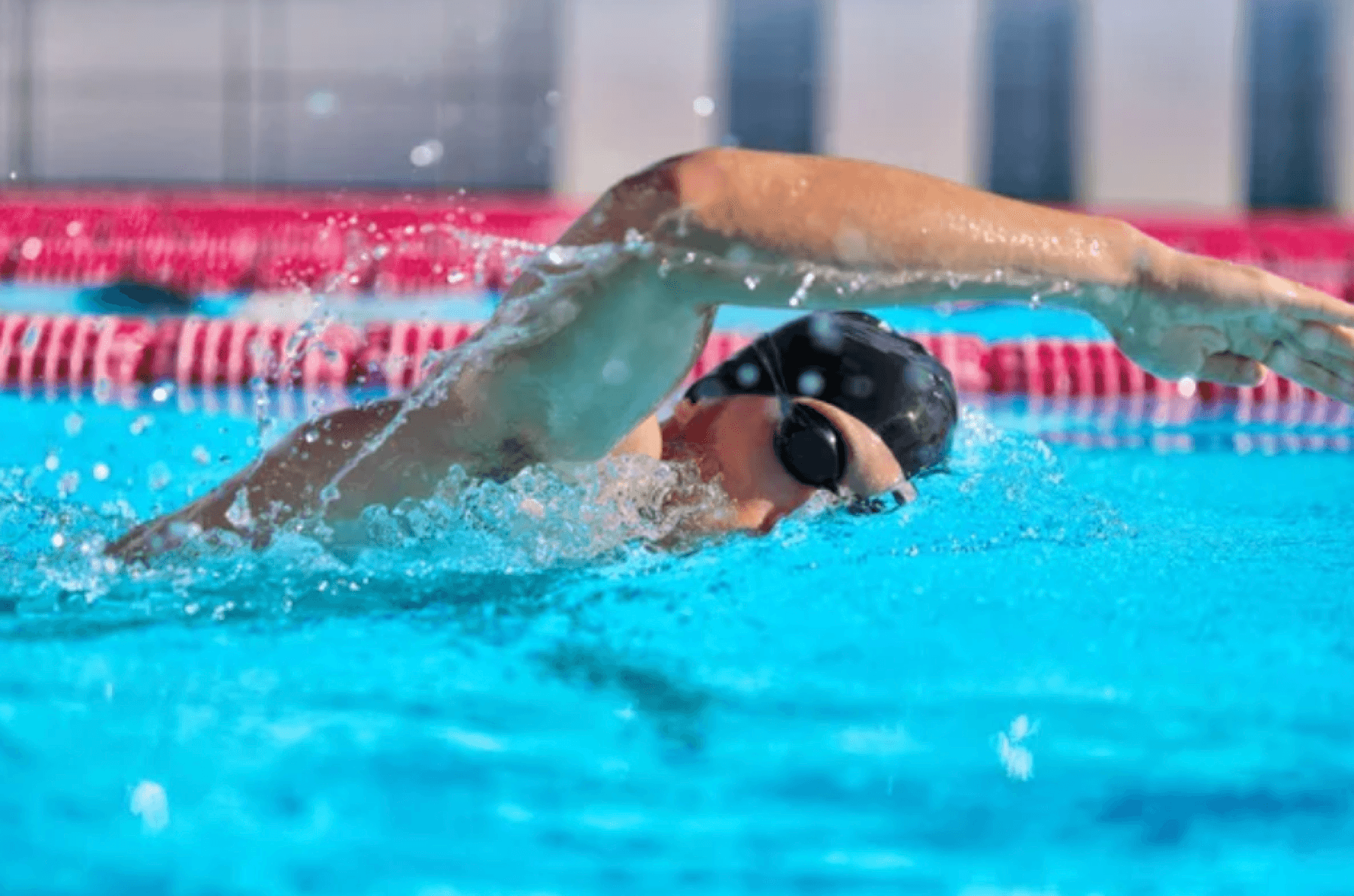 Swimmer practicing freestyle underwater in a lane